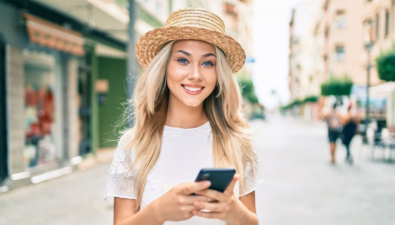 Woman in city holding smartphone